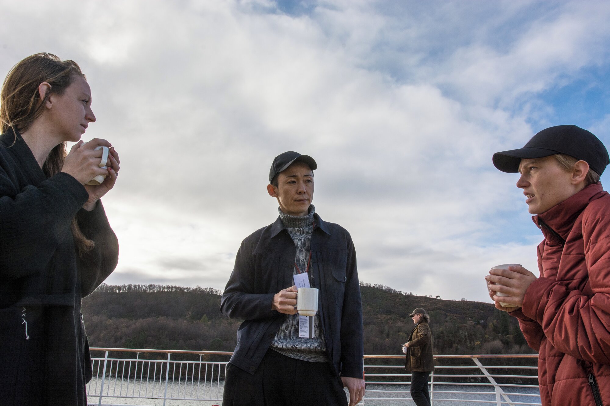 Mary Grace Wright, director of the gallery STANDARD with artists Daisuke Kosugi and Ina Hagen sailing towards Bergen harbor, 2018. Photo: Laimonas Puisys.